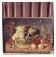 Basket of Plums and Grapes with a Fig, Nuts, Peaches and Apricots on a Ledge